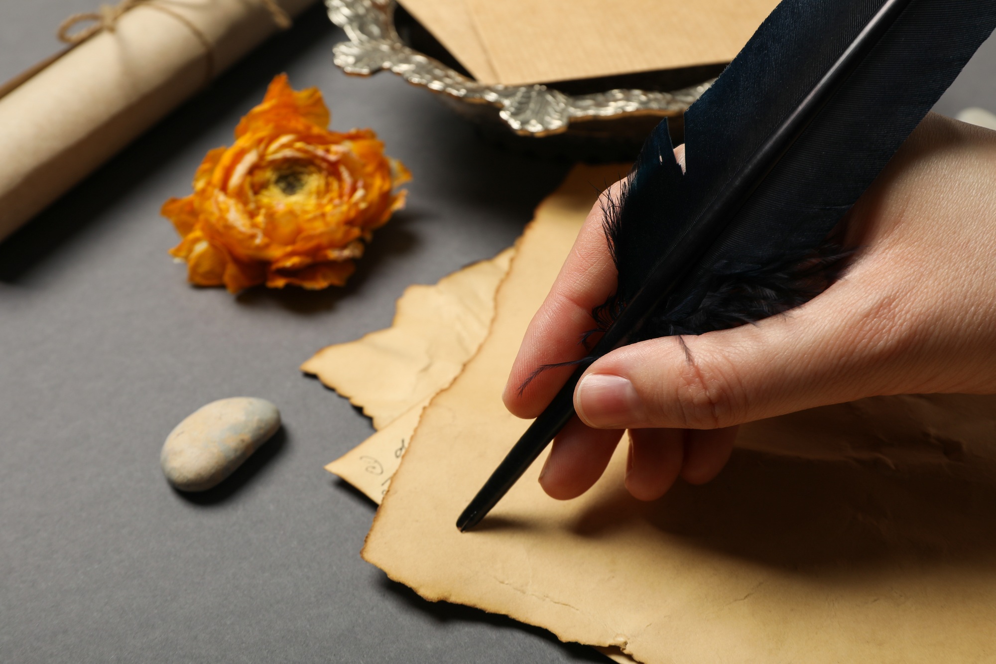 A man writes a love letter with an antique pen