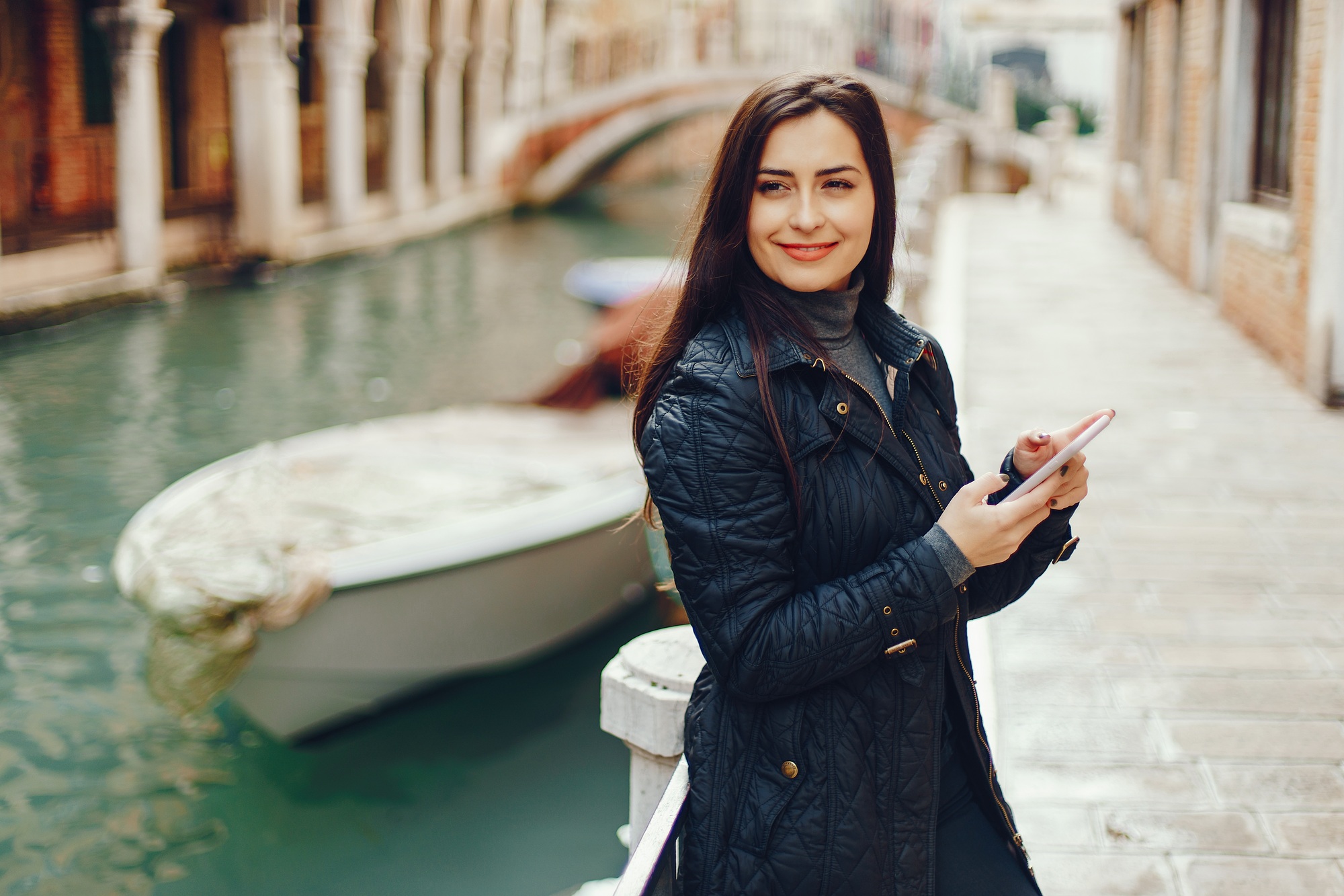 girl talking on the phone and taking pictures in Venice
