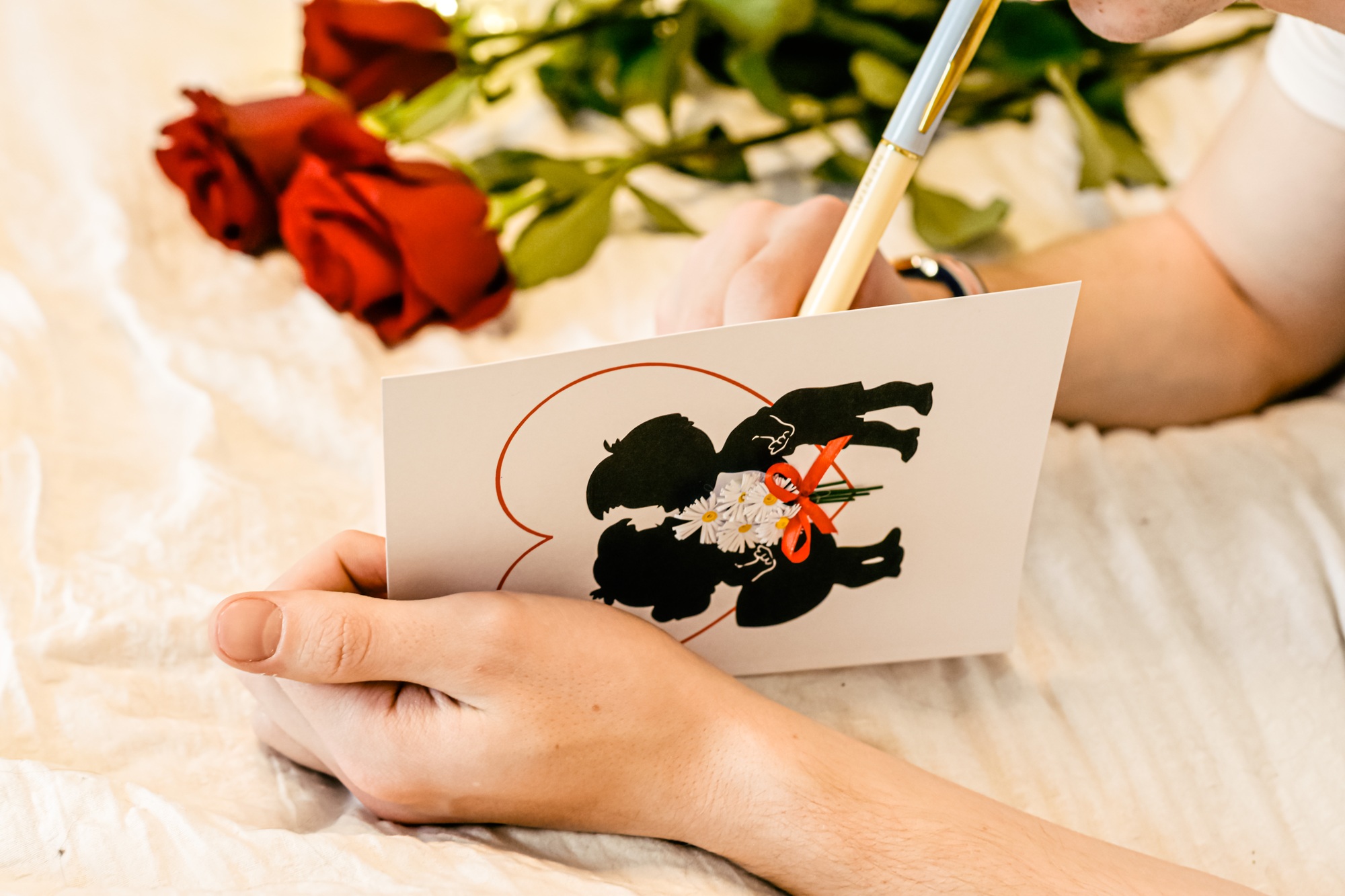 Man writing a gift card for Valentine’s Day