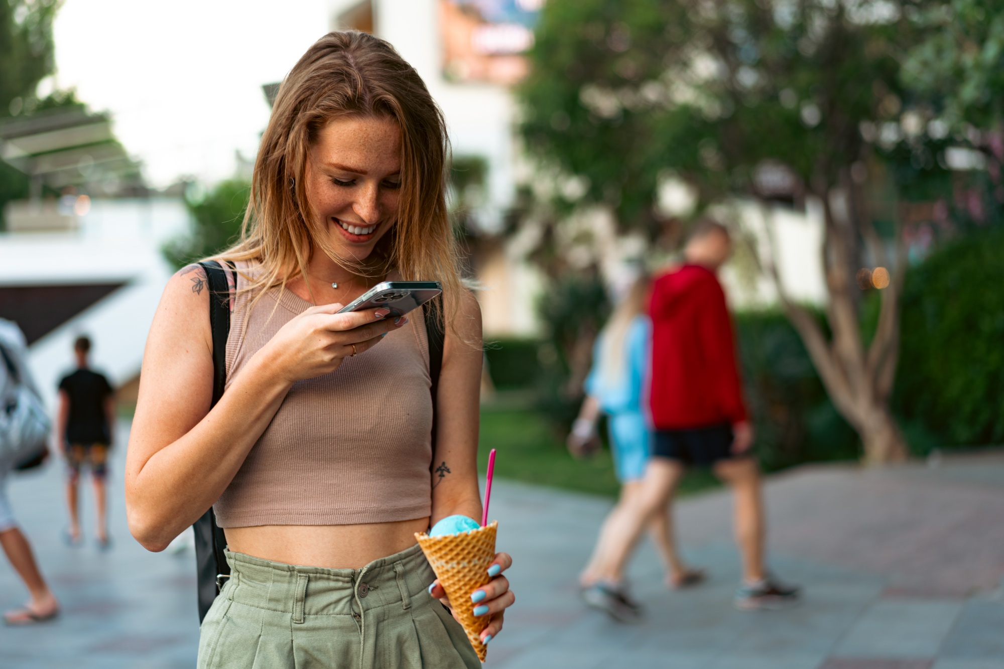 Young woman takes pictures of ice cream on her smartphone